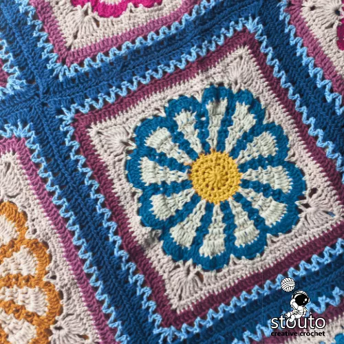 Close up of textured 3D daisy flower granny square with layered petals