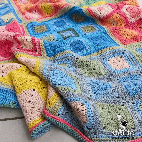 Easy crochet patchwork blanket created with simple granny squares