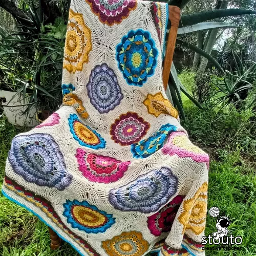 Eight different flower granny squares forming a bouquet blanket