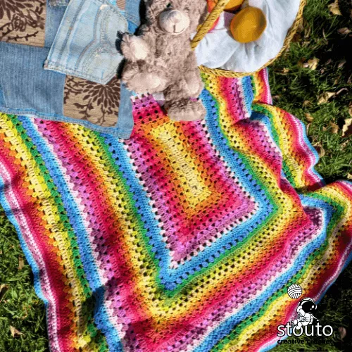 Handmade rainbow striped crochet baby blanket for nursery