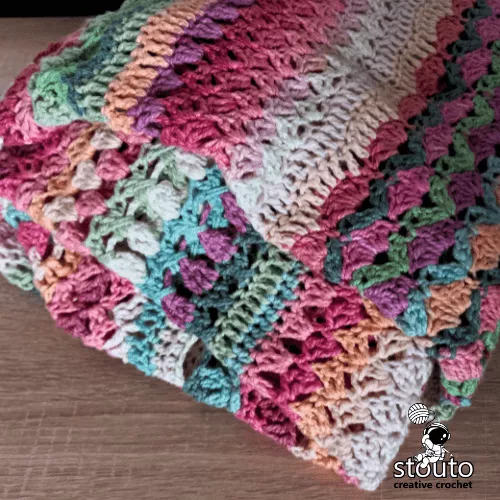 Lightweight summer crochet blanket made using airy floral stitch combinations