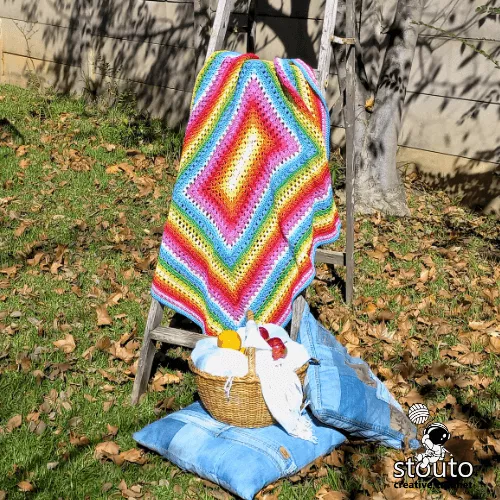 Detailed stitches of rainbow striped crochet baby blanket