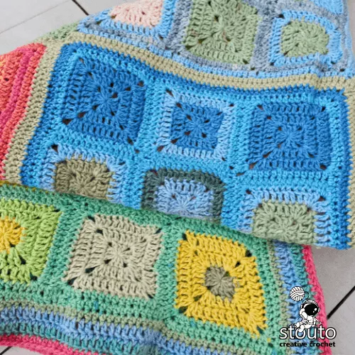 Close up of rainbow patchwork granny square blanket showing stitch texture