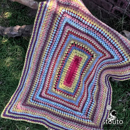 Scrap yarn baby blanket crochet pattern worked in the round using colorful leftover yarn