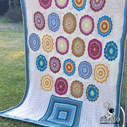 Patchwork crochet blanket pattern using multiple granny square designs.
