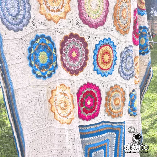 Joining granny squares with single crochet method for blanket assembly.