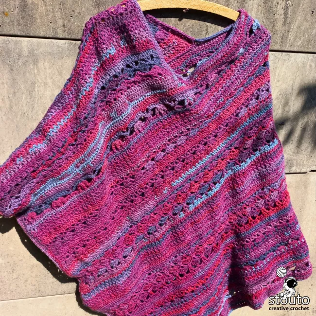 Textured stitches create a warm fabric while crochet poncho stays breathable and lightweight