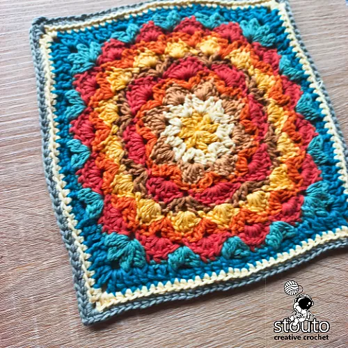 Dahlia flower granny square crochet pattern worked in soft cotton yarn