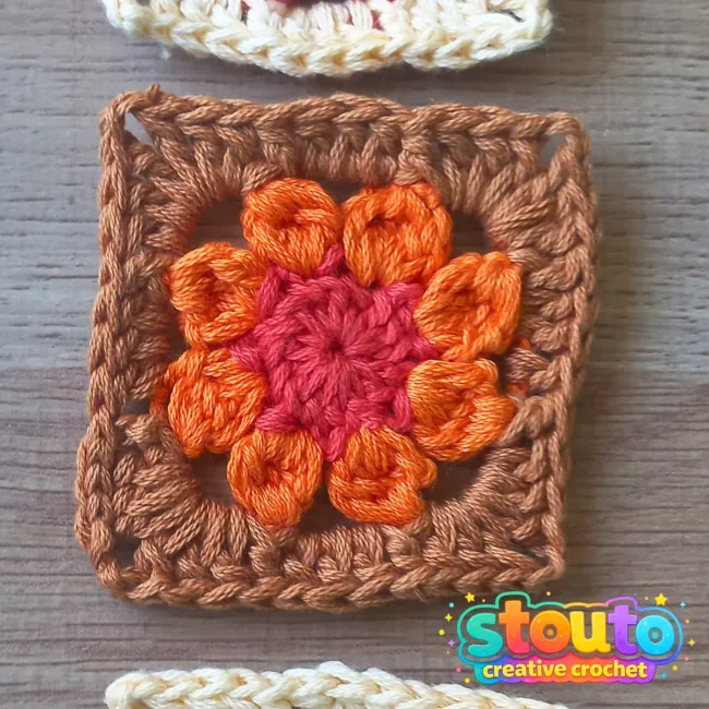 Corner detail of a small crochet flower granny square
