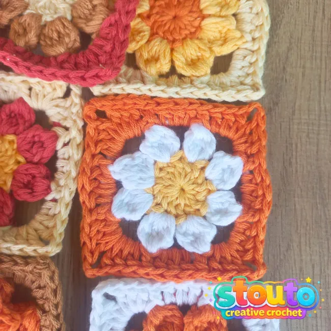 Small crochet flower granny square measuring approximately 7 x 7 cm 