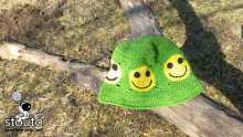 Bright green crochet bucket hat with yellow smile faces in small crochet squares