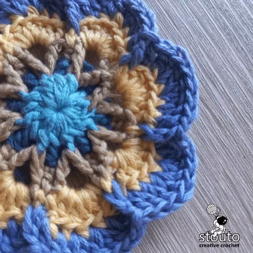 Star Flower Granny Square round 5 worked in the back loops of the shell stitches