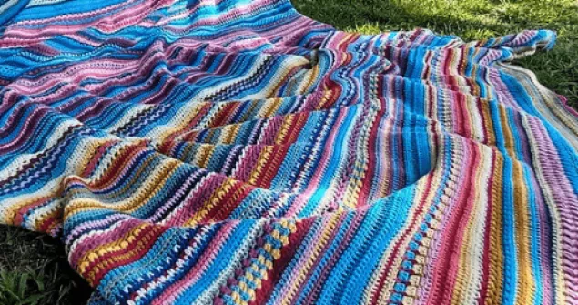 365 day crochet blanket showing daily temperature rows in colorful yarn