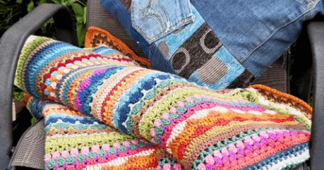 Crochet stitch sampler blanket with colourful striped texture and mixed stitches