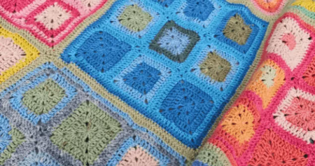 Rainbow granny square blanket layout showing vibrant patchwork arrangement