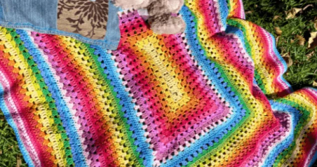 Vibrant striped crochet blanket in rainbow color sequence