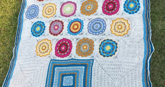 Flower pot crochet blanket pattern made with colorful granny squares.